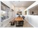 A well-lit dining room features a large wood table and scenic views at 3662 Riley Ann Ave, Las Vegas, NV 89139