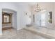 Spacious foyer with tile flooring, a chandelier, and large windows for natural light at 3662 Riley Ann Ave, Las Vegas, NV 89139