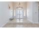Elegant foyer featuring tile flooring, frosted double doors and decorative chandelier at 3662 Riley Ann Ave, Las Vegas, NV 89139