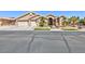 Beige single-story home with three-car garage and desert landscaping, offering curb appeal at 3662 Riley Ann Ave, Las Vegas, NV 89139