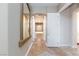 Inviting hallway with neutral tones, tiled flooring, and an arched entryway to the primary bathroom at 3662 Riley Ann Ave, Las Vegas, NV 89139