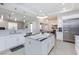 Bright kitchen with island, white cabinets, stainless steel appliances, and eat-in dining space at 3662 Riley Ann Ave, Las Vegas, NV 89139