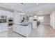 Open-concept kitchen with white cabinetry, a large island, and seamless flow to the living area at 3662 Riley Ann Ave, Las Vegas, NV 89139