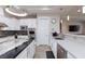 Modern kitchen showcasing white cabinetry, stone countertops, and stainless steel appliances at 3662 Riley Ann Ave, Las Vegas, NV 89139