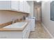 Bright laundry room featuring countertop space, a sink, washer, and dryer at 3662 Riley Ann Ave, Las Vegas, NV 89139