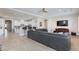 A spacious living room connects to the kitchen with a comfortable gray sofa at 3662 Riley Ann Ave, Las Vegas, NV 89139