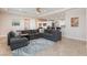 Living room with a large sectional sofa and views of the kitchen at 3662 Riley Ann Ave, Las Vegas, NV 89139