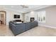 A modern living room with a fireplace, tile flooring, and a comfortable gray sofa at 3662 Riley Ann Ave, Las Vegas, NV 89139