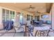A spacious covered patio with comfortable seating, ceiling fans, and outdoor lighting at 3662 Riley Ann Ave, Las Vegas, NV 89139