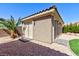 A view of the detached shed surrounded by decorative gravel, trees, and plants at 3662 Riley Ann Ave, Las Vegas, NV 89139