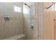 This shower features tiled walls and a built-in bench at 3662 Riley Ann Ave, Las Vegas, NV 89139