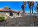 Sizeable backyard with block wall fencing offers privacy and a blank slate with dirt and patio area at 3667 Edinburgh Dr, Las Vegas, NV 89103