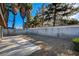 Large backyard featuring palm trees, patio, and block wall fencing providing privacy and space for recreation at 3667 Edinburgh Dr, Las Vegas, NV 89103