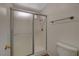 Modern bathroom with a white shower featuring a sliding glass door, chrome fixtures, and a low-flow toilet at 3667 Edinburgh Dr, Las Vegas, NV 89103