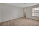 Well-lit bedroom offers comfort with carpeted floors and a view through the window at 3667 Edinburgh Dr, Las Vegas, NV 89103