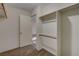 Well-lit walk-in closet with carpet and open door showcasing ample storage with wooden rods and adjustable shelving at 3667 Edinburgh Dr, Las Vegas, NV 89103