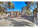 Gated community entrance provides security and privacy with a guard house, automatic gates, and lush landscaping at 3667 Edinburgh Dr, Las Vegas, NV 89103