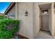 Home's front door with classic sconces and a tidy green hedge, offering curb appeal and a warm welcome at 3667 Edinburgh Dr, Las Vegas, NV 89103
