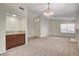 Open-concept living room featuring neutral carpet, wet bar, fireplace and natural light at 3667 Edinburgh Dr, Las Vegas, NV 89103