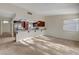 Bright living room featuring plush carpeting, direct access to the front entrance and kitchen access at 3667 Edinburgh Dr, Las Vegas, NV 89103