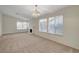 Expansive living room with neutral carpet, fireplace, chandelier, and large windows for ample natural light at 3667 Edinburgh Dr, Las Vegas, NV 89103