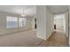 Bright living room featuring neutral carpet, a chandelier, and a seamless transition to a tiled hallway at 3667 Edinburgh Dr, Las Vegas, NV 89103