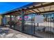 Seating and signage at the community pool, all enclosed in a black metal fence at 3667 Edinburgh Dr, Las Vegas, NV 89103