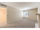 Bright living room featuring light carpeting and a view of a charming fireplace at 3683 Villa Knolls East Dr, Las Vegas, NV 89120