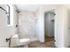Modern bathroom with marble-tiled shower, new toilet, and sleek fixtures, adjacent to a closet for added convenience at 3914 Steinbeck Dr, Las Vegas, NV 89115