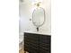 Modern bathroom featuring a sleek vanity, black fixtures, quartz countertop, stylish mirror, and a contemporary toilet at 3914 Steinbeck Dr, Las Vegas, NV 89115