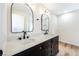 Elegant bathroom with dual sinks, marble countertop, dark wood vanity, modern fixtures, and wood-look flooring at 3914 Steinbeck Dr, Las Vegas, NV 89115