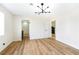 Spacious bedroom with stylish light fixture and wood-look floors at 3914 Steinbeck Dr, Las Vegas, NV 89115