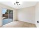 Bedroom with updated light fixture and sliding glass door to backyard at 3914 Steinbeck Dr, Las Vegas, NV 89115