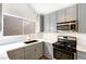 Well-appointed kitchen featuring gray cabinets, quartz countertops, stainless steel appliances, and a stylish, modern faucet at 3914 Steinbeck Dr, Las Vegas, NV 89115