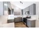 Modern kitchen with gray cabinets, quartz countertops, stainless steel appliances, and wood-look flooring at 3914 Steinbeck Dr, Las Vegas, NV 89115