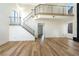 Open-concept living room featuring stairs to loft and wood-look flooring at 3914 Steinbeck Dr, Las Vegas, NV 89115