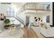 Bright, open living space with modern decor, sleek staircase, and seamless transition to dining area, and plenty of natural light at 3914 Steinbeck Dr, Las Vegas, NV 89115