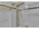 This elegant shower with gold hardware features sleek controls and a rainfall shower head at 3930 University Center Dr # 909, Las Vegas, NV 89119