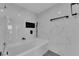 Bathtub features modern fixtures, marble wall, and a shower at 3930 University Center Dr # 909, Las Vegas, NV 89119