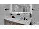 Bathroom featuring double sinks, marble countertops, and a lighted mirror at 3930 University Center Dr # 909, Las Vegas, NV 89119