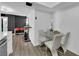 Bright dining area featuring a glass table, white chairs, and modern decor at 3930 University Center Dr # 909, Las Vegas, NV 89119