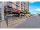 Building entrance with a red awning, well-maintained landscaping, and easy access to the interior at 3930 University Center Dr # 909, Las Vegas, NV 89119