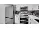 Modern kitchen featuring stainless steel appliances, white cabinetry, and stylish design elements at 3930 University Center Dr # 909, Las Vegas, NV 89119