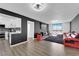 Spacious living room featuring a modern black and red sectional sofa, city views, and sleek wall accents at 3930 University Center Dr # 909, Las Vegas, NV 89119
