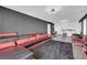 Bright living room showcasing a stylish black and red sectional, textured wall, and modern decor at 3930 University Center Dr # 909, Las Vegas, NV 89119