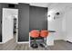 Stylish office nook featuring gray wood slats, a black desk, and comfortable orange chairs at 3930 University Center Dr # 909, Las Vegas, NV 89119