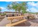 Inviting outdoor dining space with picnic tables, BBQ grills, and scenic views under a leafy tree at 3930 University Center Dr # 909, Las Vegas, NV 89119