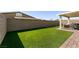 Spacious backyard featuring lush artificial turf and a well-maintained privacy wall, ideal for outdoor activities at 4227 Diya Ave, North Las Vegas, NV 89084