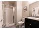 Bathroom featuring glass enclosed shower, vanity with granite countertops, and black cabinets at 4227 Diya Ave, North Las Vegas, NV 89084