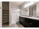 Modern bathroom with double sinks, granite countertops, and a glass-enclosed shower at 4227 Diya Ave, North Las Vegas, NV 89084